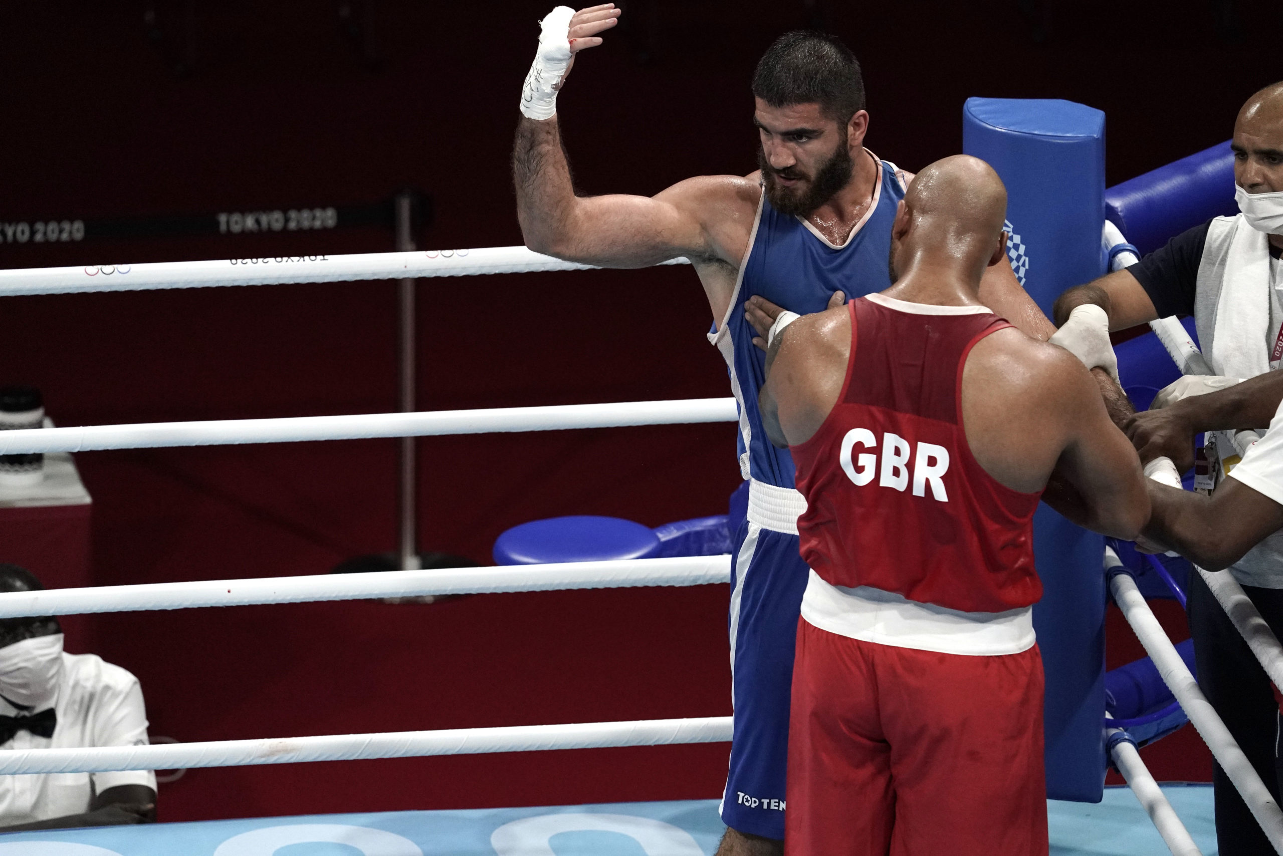Mourad Aliev (FRA), blue shorts, yells at officials after being disqualified in his men's super heavy quarterfinal bout against Frazer Clarke (GBR), red shorts, during the Tokyo 2020 Olympic Summer Games at Kokugikan Arena
