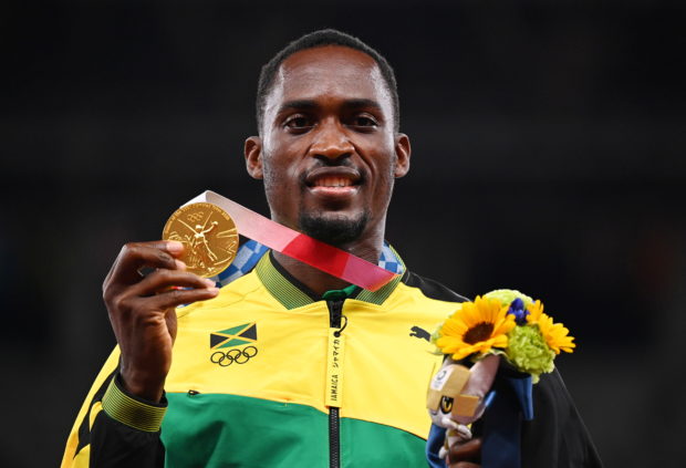 Gold medallist, Hansle Parchment of Jamaica poses on the podium REUTERS/Dylan Martinez/File Photo