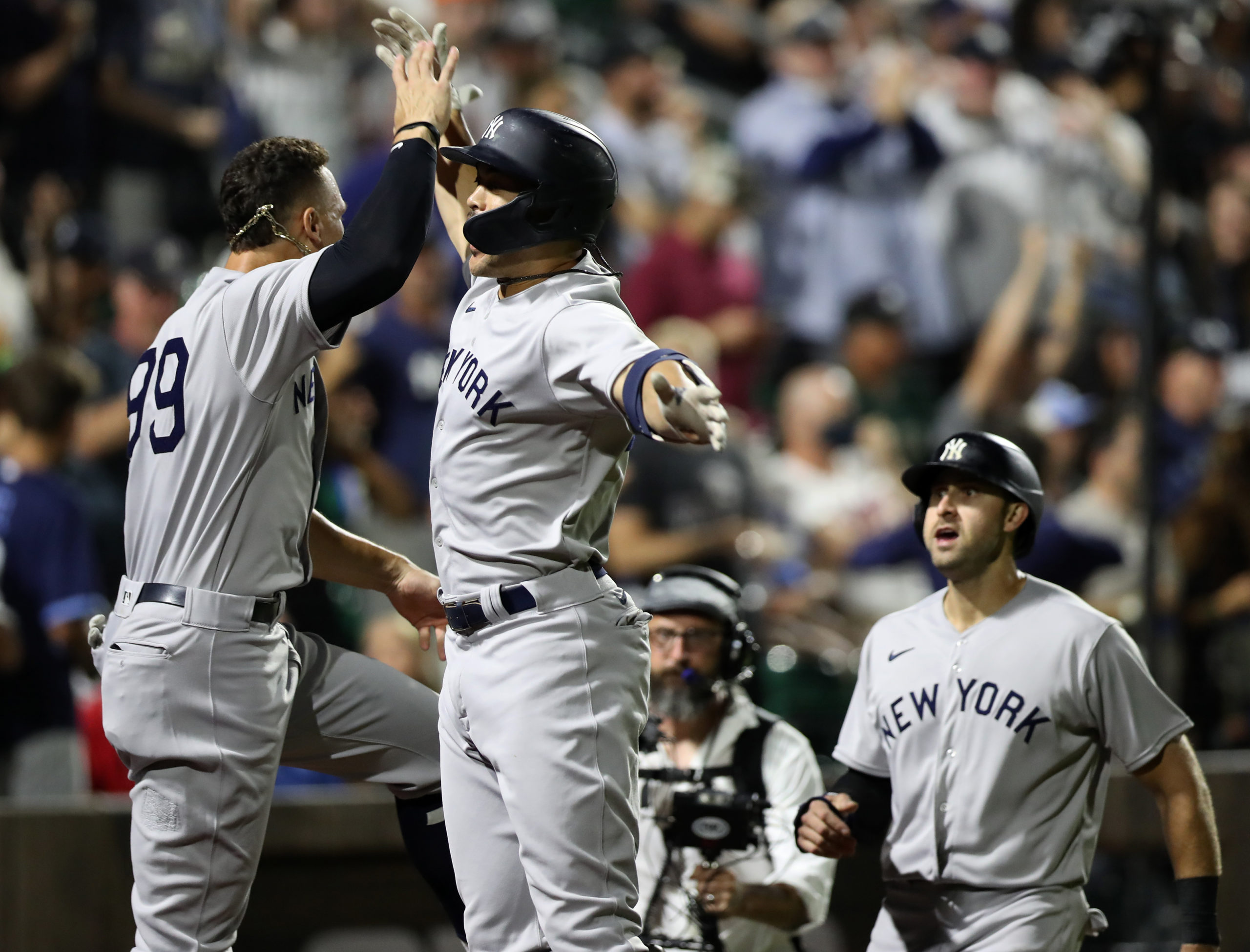 Yankees designated hitter Giancarlo Stanton (middle) celebrates with right fielder Aaron Judge (99) after hitting a home run against the Chicago White Sox during the ninth inning at the Field of Dreams.
