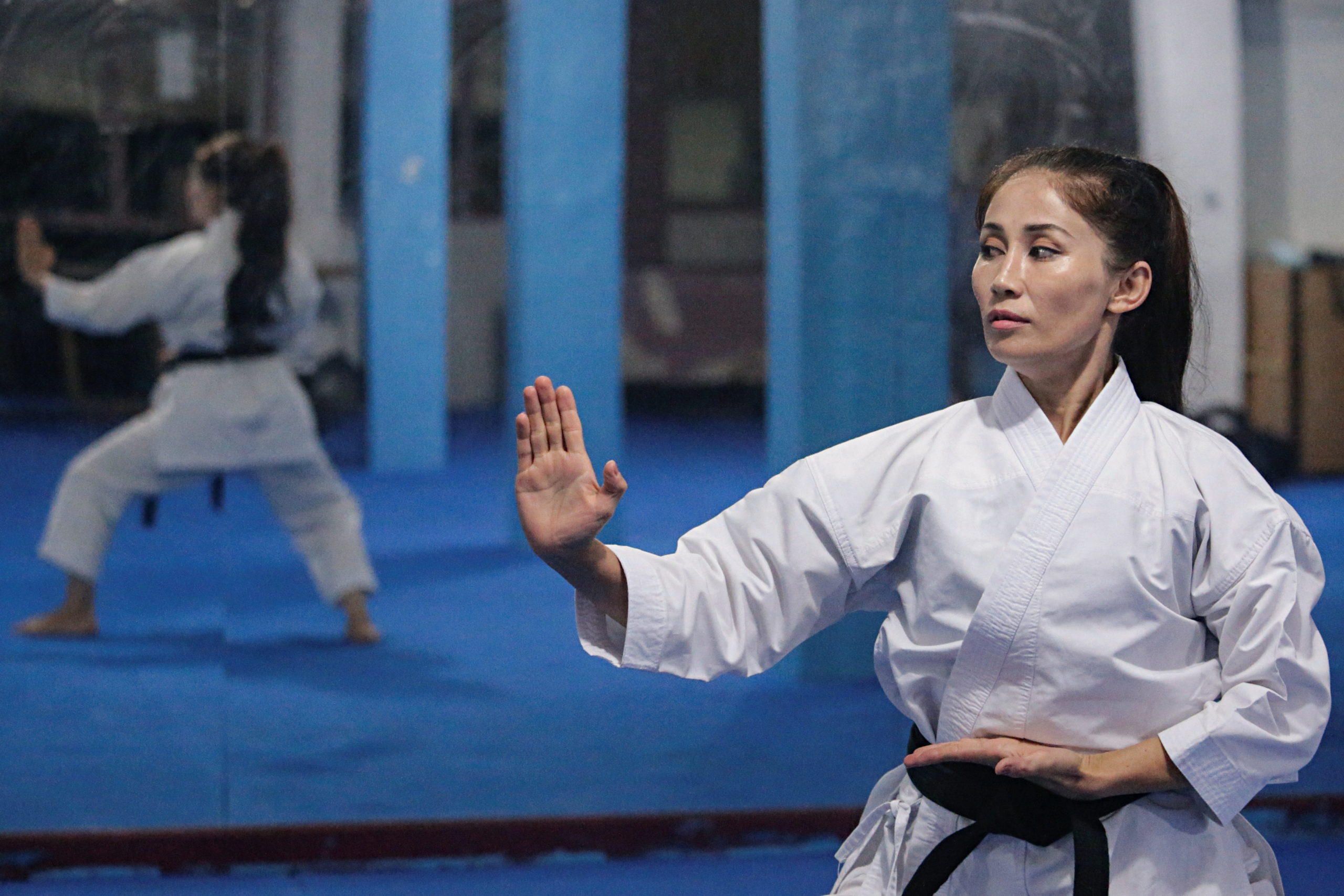 Meena Asadi, a 28-year-old former Afghan martial arts athlete practices karate at the Refugee Shotokan Club dojo in Cisarua, West Java province, Indonesia, August 18, 2021. Picture taken August 18, 2021. 