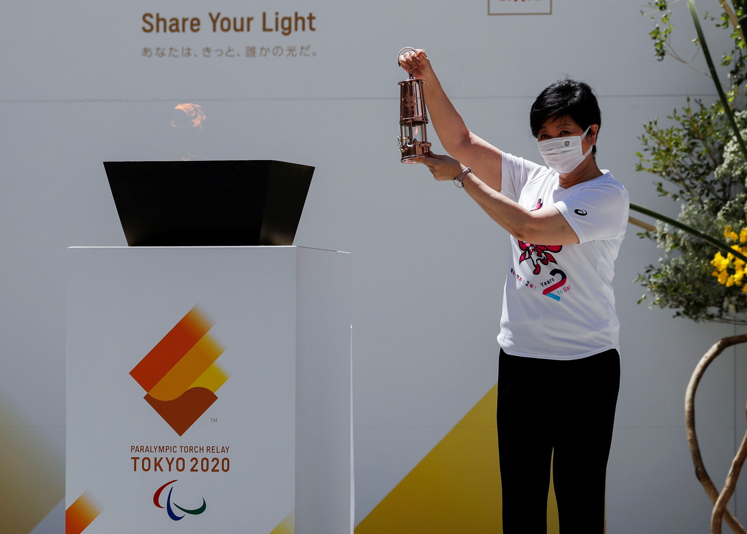 Tokyo Governor Yuriko Koike holds the Paralympic torch lantern during the flame gathering event to merge flames collected from 62 municipalities within the Japanese capital into one, in Tokyo, Japan, August 20, 2021.