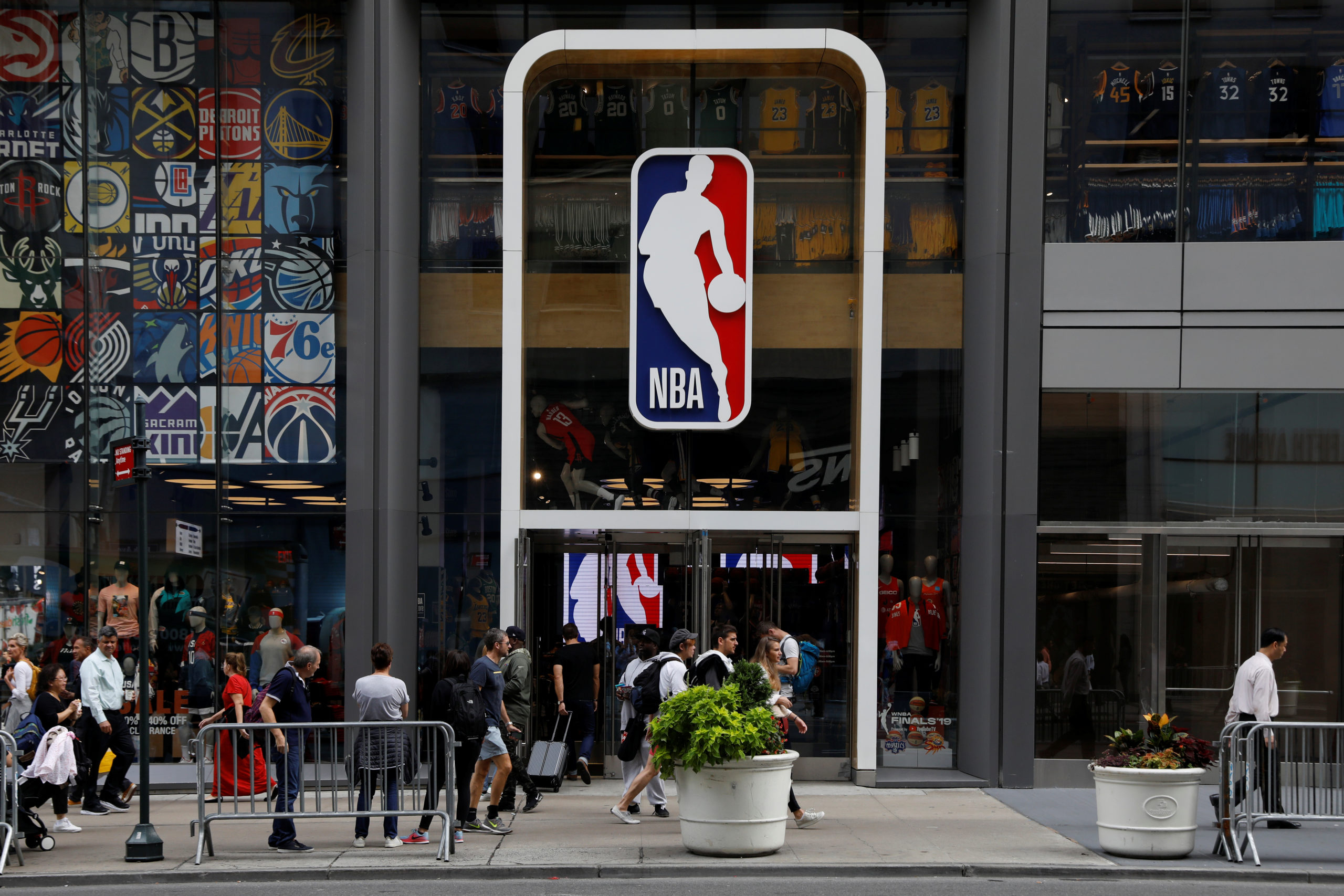 The NBA logo is displayed as people pass by the NBA Store in New York City, U.S., October 7, 2019. REUTERS/Brendan McDermid