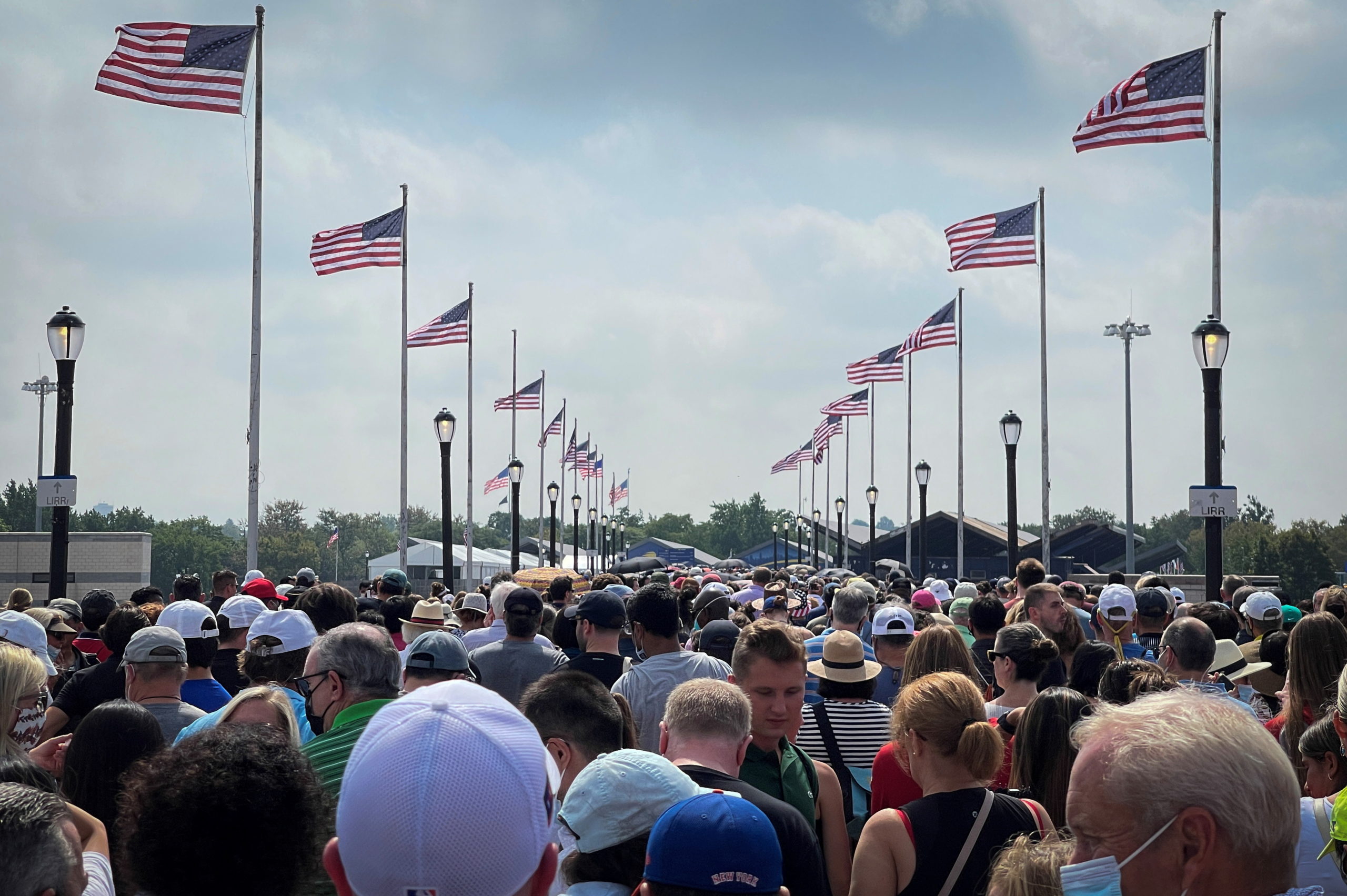 FILE PHOTO: Tennis fans, who are required to show proof of vaccination against the coronavirus disease (COVID-19), stand in a long line to enter the grounds of the USTA Billie King National Tennis Center on the first day of the 2021 U.S. Open tennis tournament, in the Queens borough of New York City, New York, U.S. August 30, 2021. 