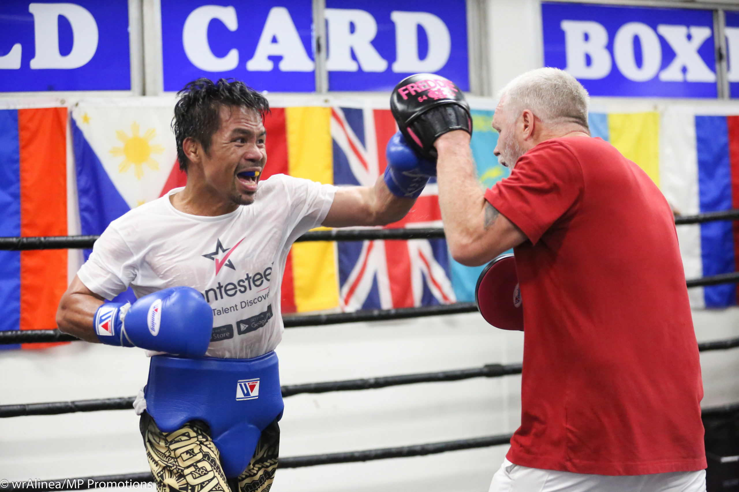 Manny Pacquiao does mitts with trainer Freddie Roach. 