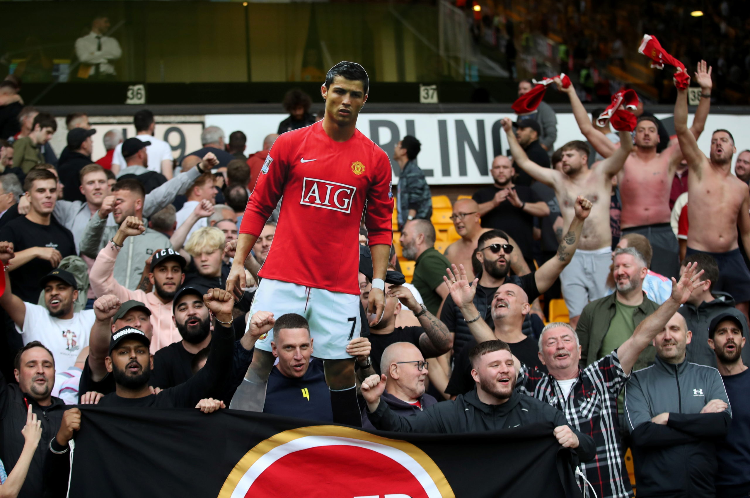 Manchester United fans celebrate with a cardboard cut out of Cristiano Ronaldo after the match