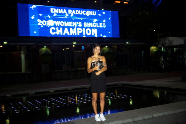 Britain's Emma Raducanu poses with the U.S. Open tennis championship trophy after her match against Leylah Fernandez of Canada in the women's singles final the 2021 U.S. Open tennis tournament at USTA Billie Jean King National Tennis C