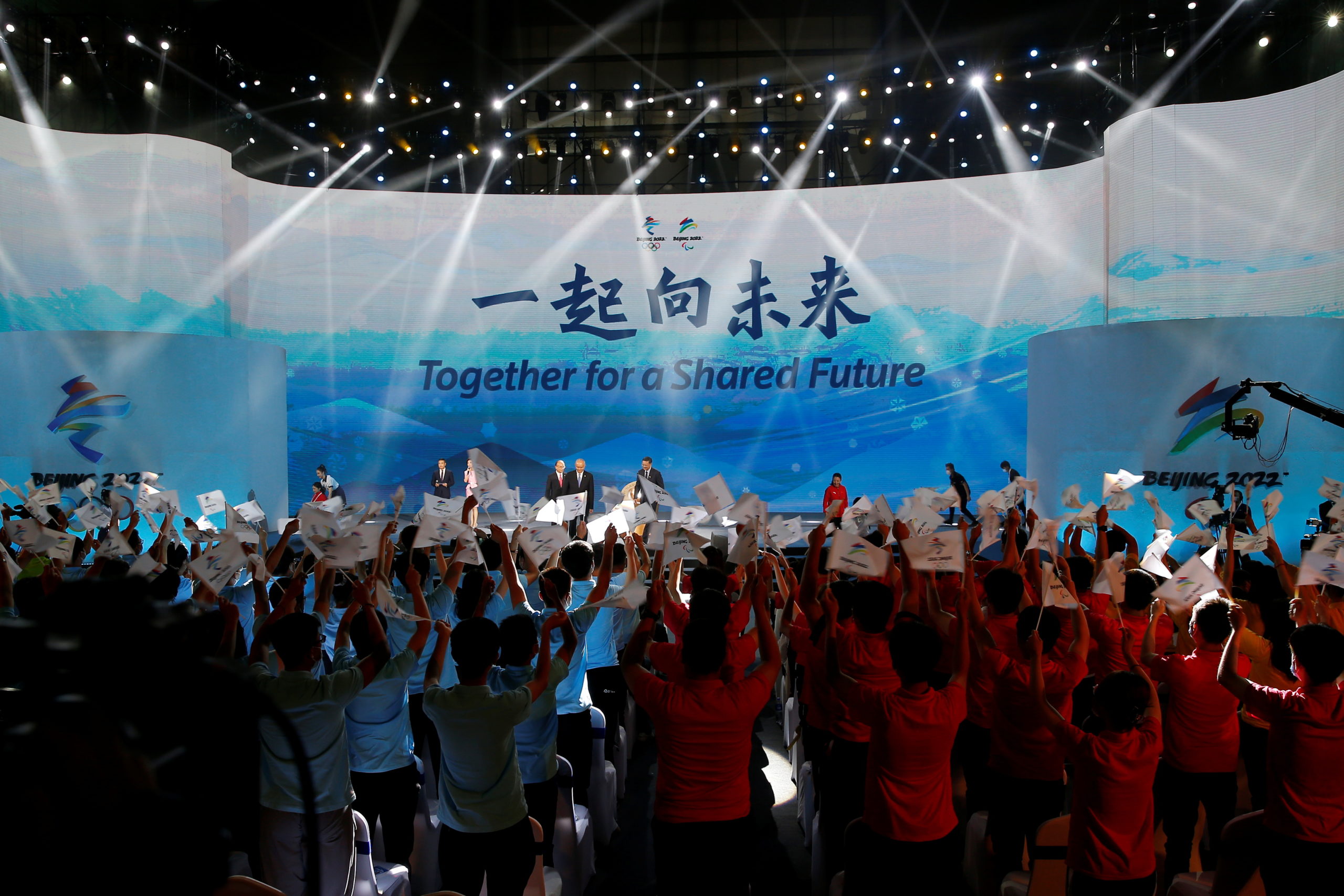 The slogan for the Beijing 2022 Winter Olympics, "Together for a shared future", is unveiled on a giant screen at a ceremony in Beijing, China 