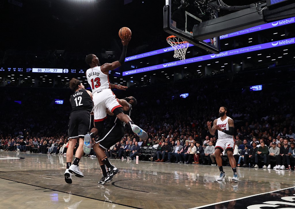 Bam Adebayo #13 of the Miami Heat shoots against James Harden #13 of the Brooklyn Nets during their game at Barclays Center on October 27, 2021 in New York City. NOTE TO USER: User expressly acknowledges and agrees that, by downloading and or using this photograph, User is consenting to the terms and conditions of the Getty Images License Agreement. 