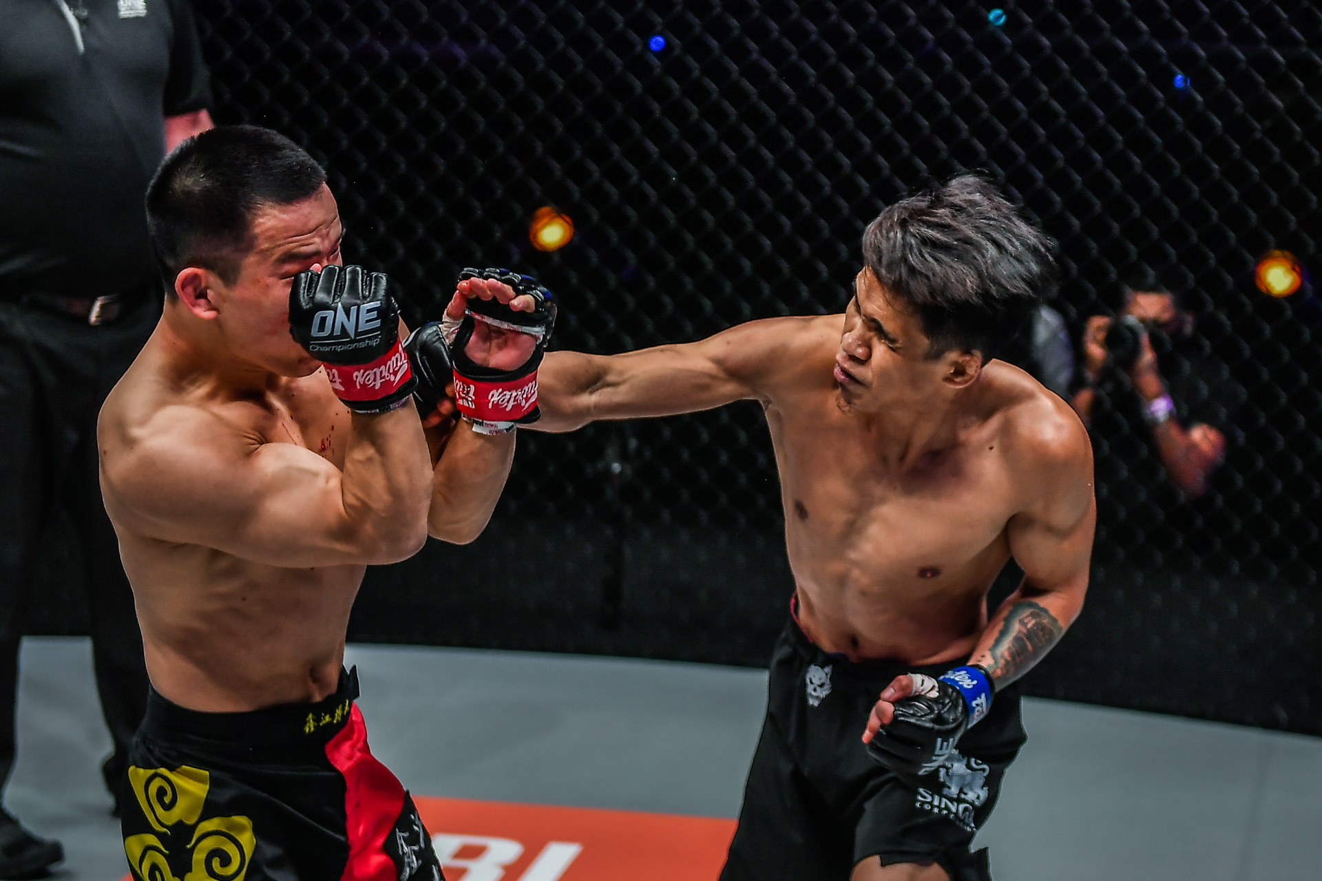 Jeremy Miado throws a punch against China’s Miao Li Tao. 