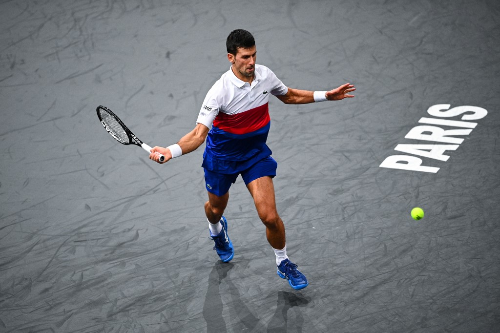 Serbia's Novak Djokovic returns the ball to Hungary's Marton Fucsovics (not pictured) during their men's singles tennis match on day two of the ATP Paris Masters at The AccorHotels Arena in Paris on November 2, 2021