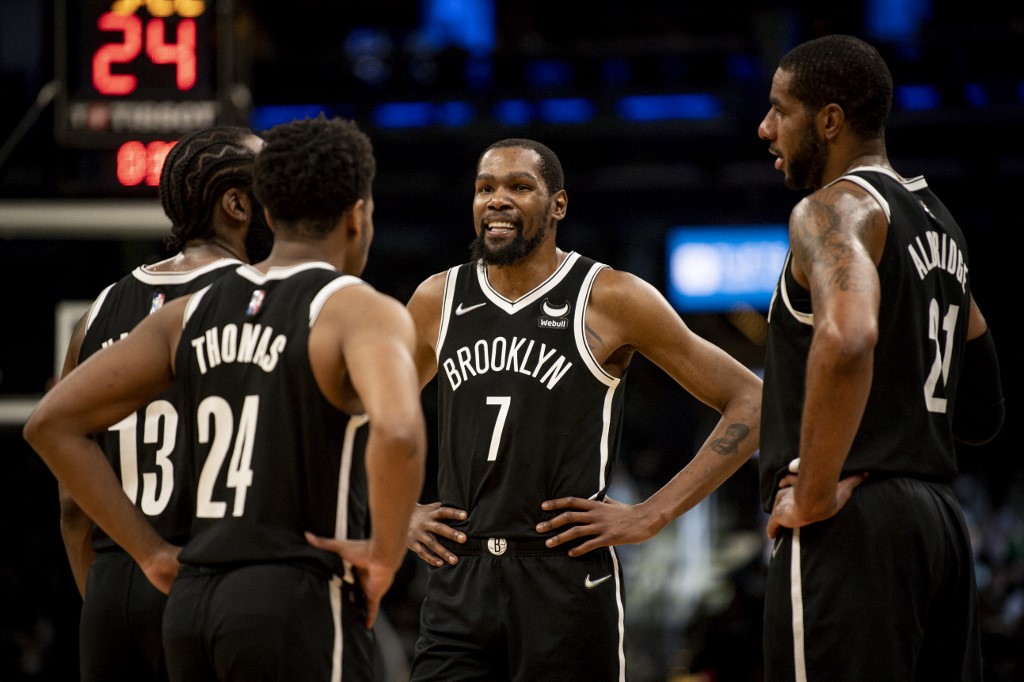Kevin Durant #7 of the Brooklyn Nets talks with teammates during a timeout against the Boston Celtics at TD Garden on November 24, 2021 in Boston, Massachusetts.