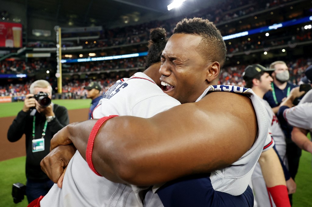 Jorge Soler #12 and Ozzie Albies #1 of the Atlanta Braves celebrate their 7-0 victory against the Houston Astros in Game Six to win the 2021 World Series at Minute Maid Park on November 02, 2021 in Houston, Texas. 