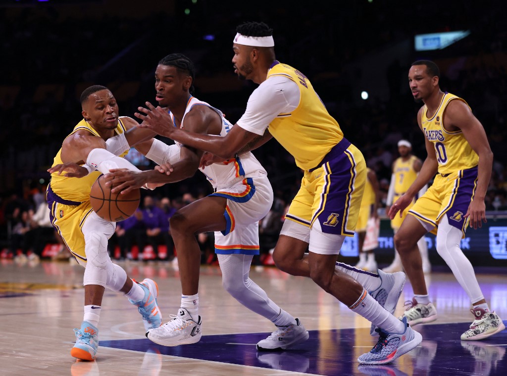  Shai Gilgeous-Alexander #2 of the Oklahoma City Thunder tries to keep his dribble from Russell Westbrook #0 and Kent Bazemore #9 and Avery Bradley #20 of the Los Angeles Lakers during the first half at Staples Center on November 04, 2021 in Los Angeles, California.   