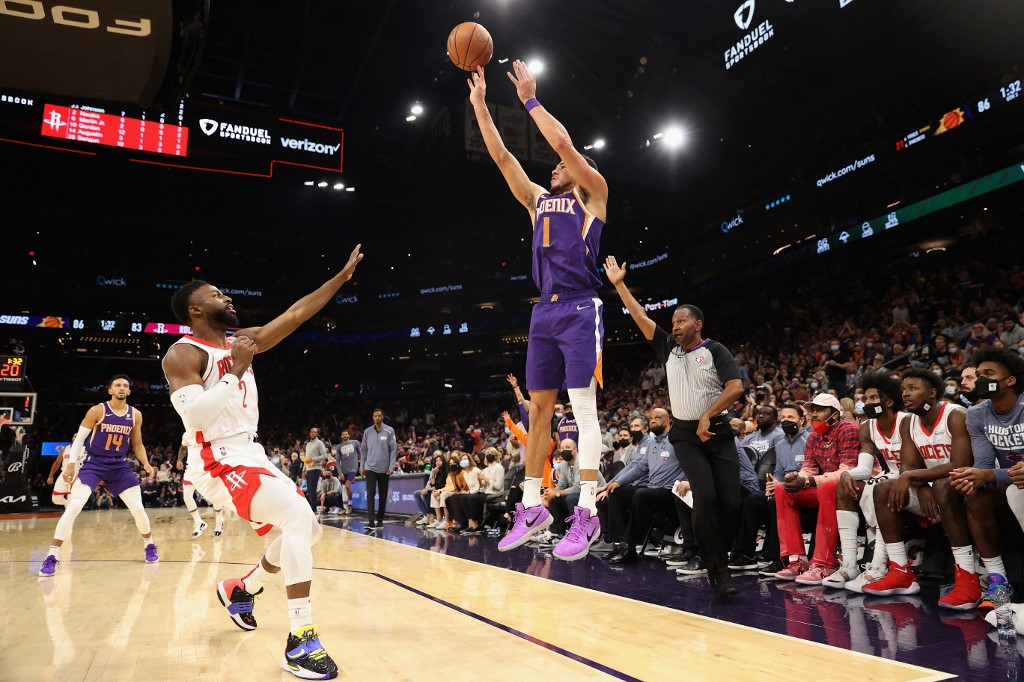 Devin Booker #1 of the Phoenix Suns puts up a three-point shot over David Nwaba #2 of the Houston Rockets during the second half of the NBA game at Footprint Center on November 04, 2021 in Phoenix, Arizona. 