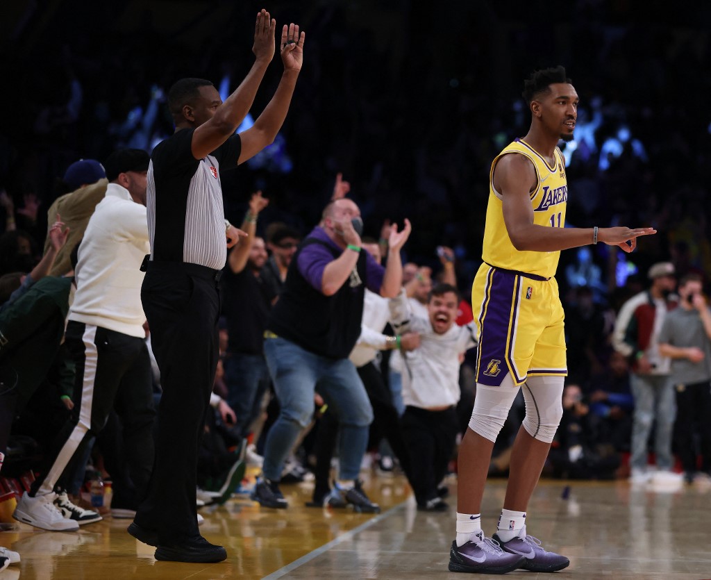 Malik Monk #11 of the Los Angeles Lakers reacts to his three pointer at the buzzer to end the third quarter during a 126-123 Lakers overtime win at Staples Center on November 08, 2021 in Los Angeles, California.   