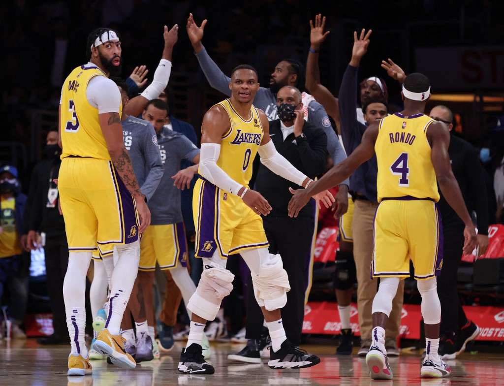 Russell Westbrook #0 of the Los Angeles Lakers reacts to a three pointer from Wayne Ellington #2 with Anthony Davis #3 and Rajon Rondo #4, to take a during a 126-123 Lakers overtime win at Staples Center on November 08, 2021 in Los Angeles, California.   