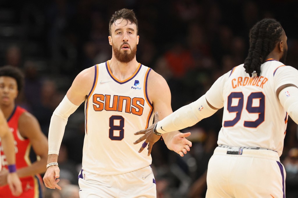 Frank Kaminsky #8 of the Phoenix Suns high fives Jae Crowder #99 during the NBA game at Footprint Center on November 02, 2021 in Phoenix, Arizona. The Suns defeated the Pelicans 112-100.