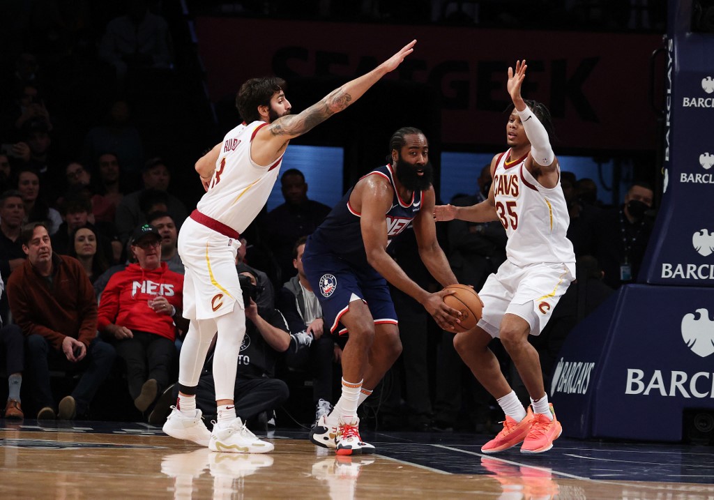 James Harden #13 of the Brooklyn Nets is defended by Ricky Rubio #3 and Isaac Okoro #35 of the Cleveland Cavaliers during their game at Barclays Center on November 17, 2021 in New York City.   