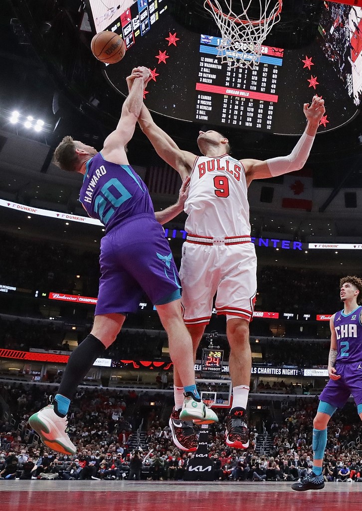 Gordon Hayward #20 of the Charlotte Hornets tries to get off a shot against Nikola Vucevic #9 of the Chicago Bulls at the United Center on November 29, 2021 in Chicago, Illinois. 