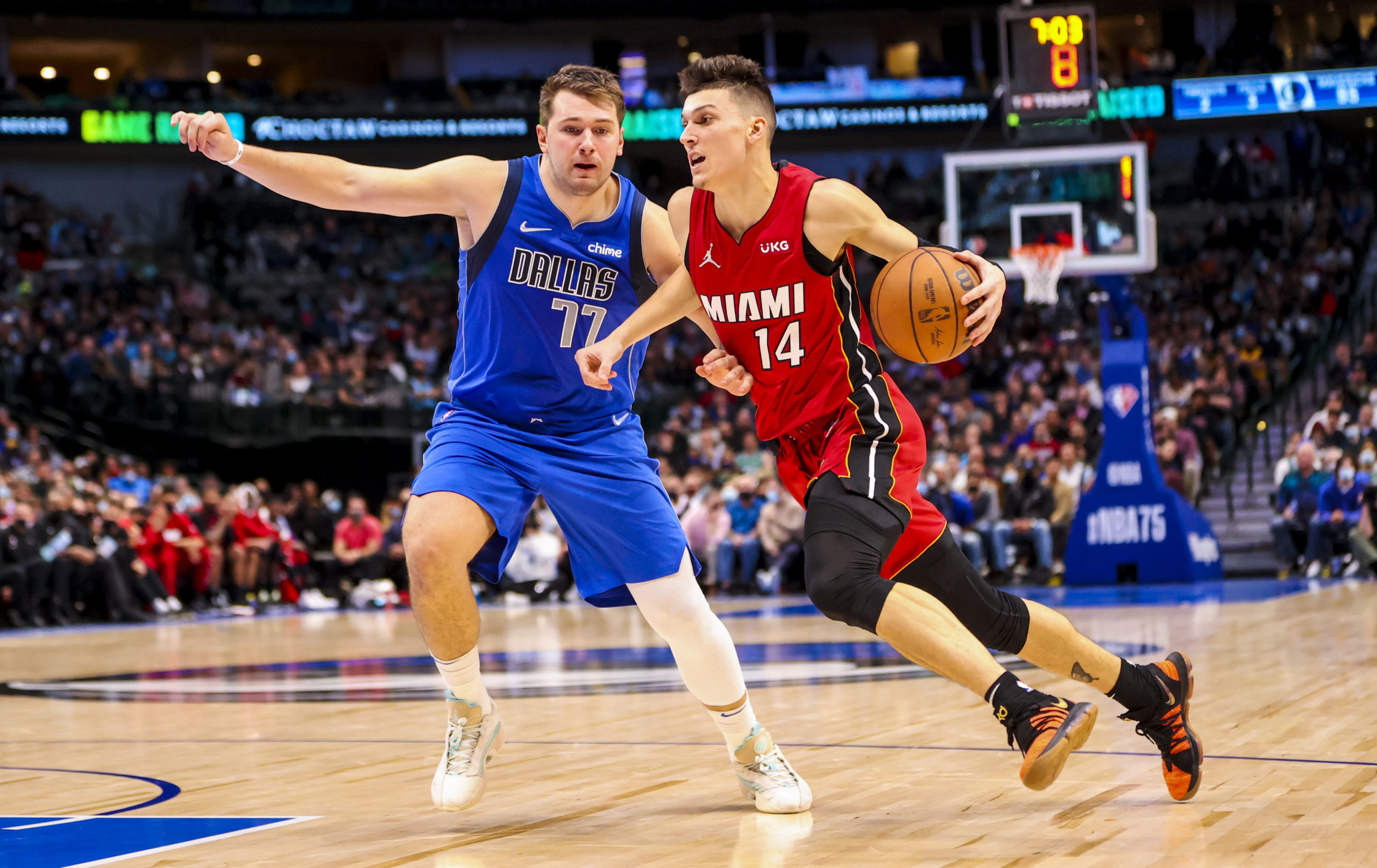 Miami Heat guard Tyler Herro (14) drives to the basket as Dallas Mavericks guard Luka Doncic (77) defends during the fourth quarter at American Airlines 
