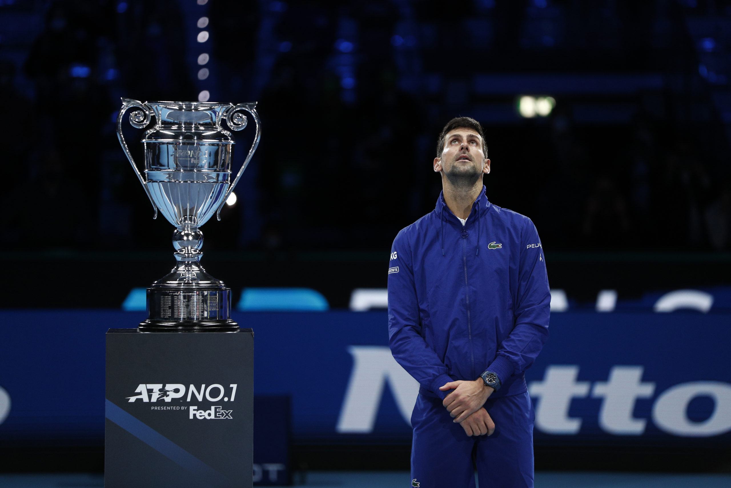 erbia's Novak Djokovic with the trophy for his 2021 world number one ranking after winning his group stage match against Norway's Casper Ruud 