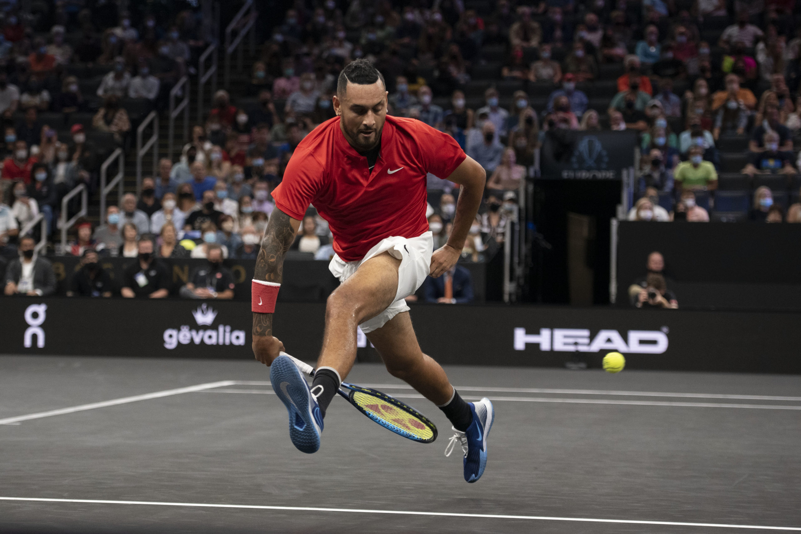 Team World player Nick Kyrgios attempts a shot between his legs during the first set of his match against Team Europe player Stefanos Tsitsipas at TD Garden. 