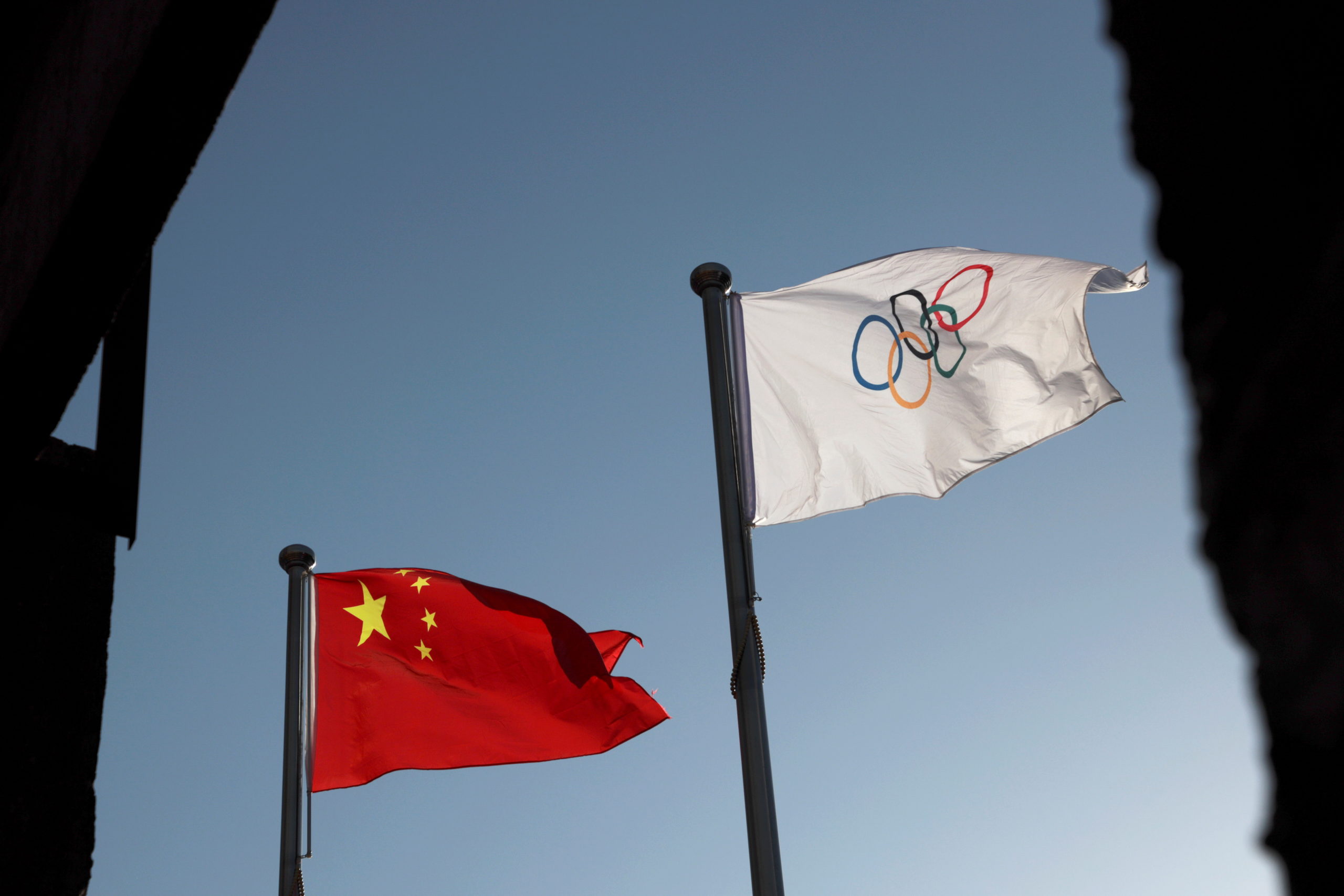 FILE PHOTO: The Chinese and Olympic flags flutter at the headquarters of the Beijing Organising Committee for the 2022 Olympic and Paralympic Winter Games in Beijing, China November 12, 2021.