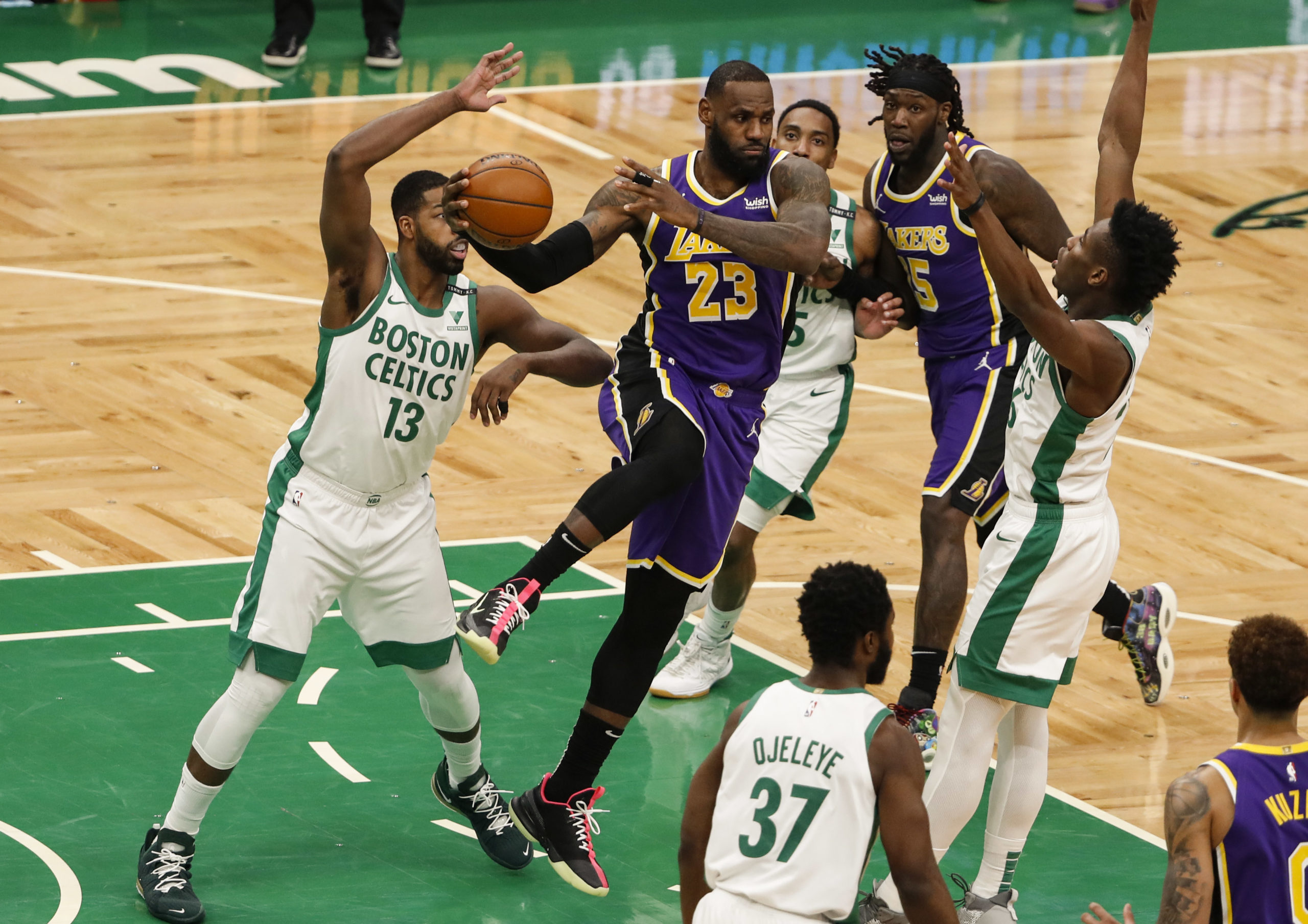 Los Angeles Lakers forward LeBron James (23) looks to pass as he is surrounded by Boston Celtics players during the fourth quarter at TD Garden.