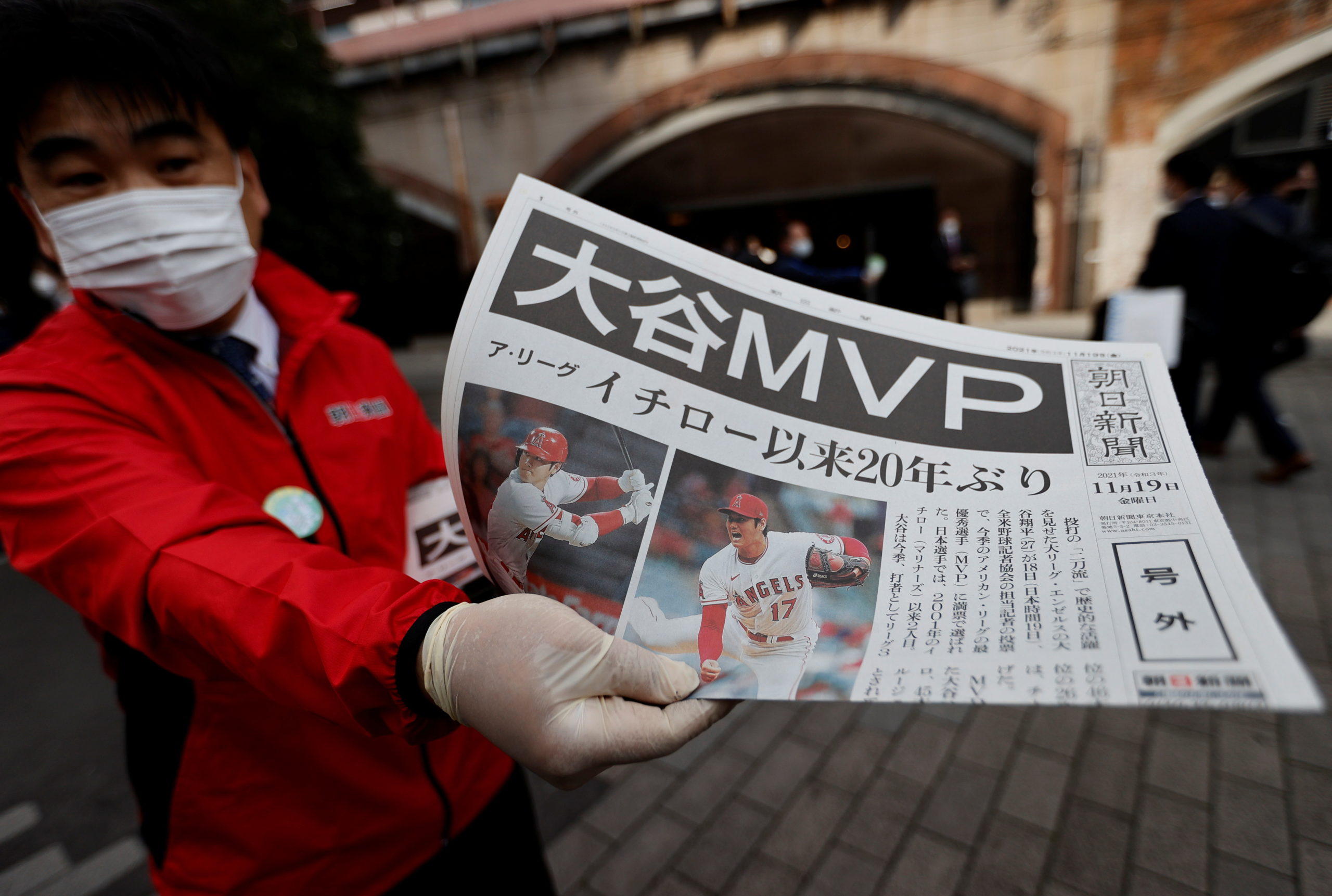 A worker from a newspaper company distributes extra editions of a newspaper, reporting Japan's Shohei Ohtani of the Los Angeles Angels was named Most Valuable Player of Major League Baseball's American League, in Tokyo, Japan Japan November 19, 2021. 