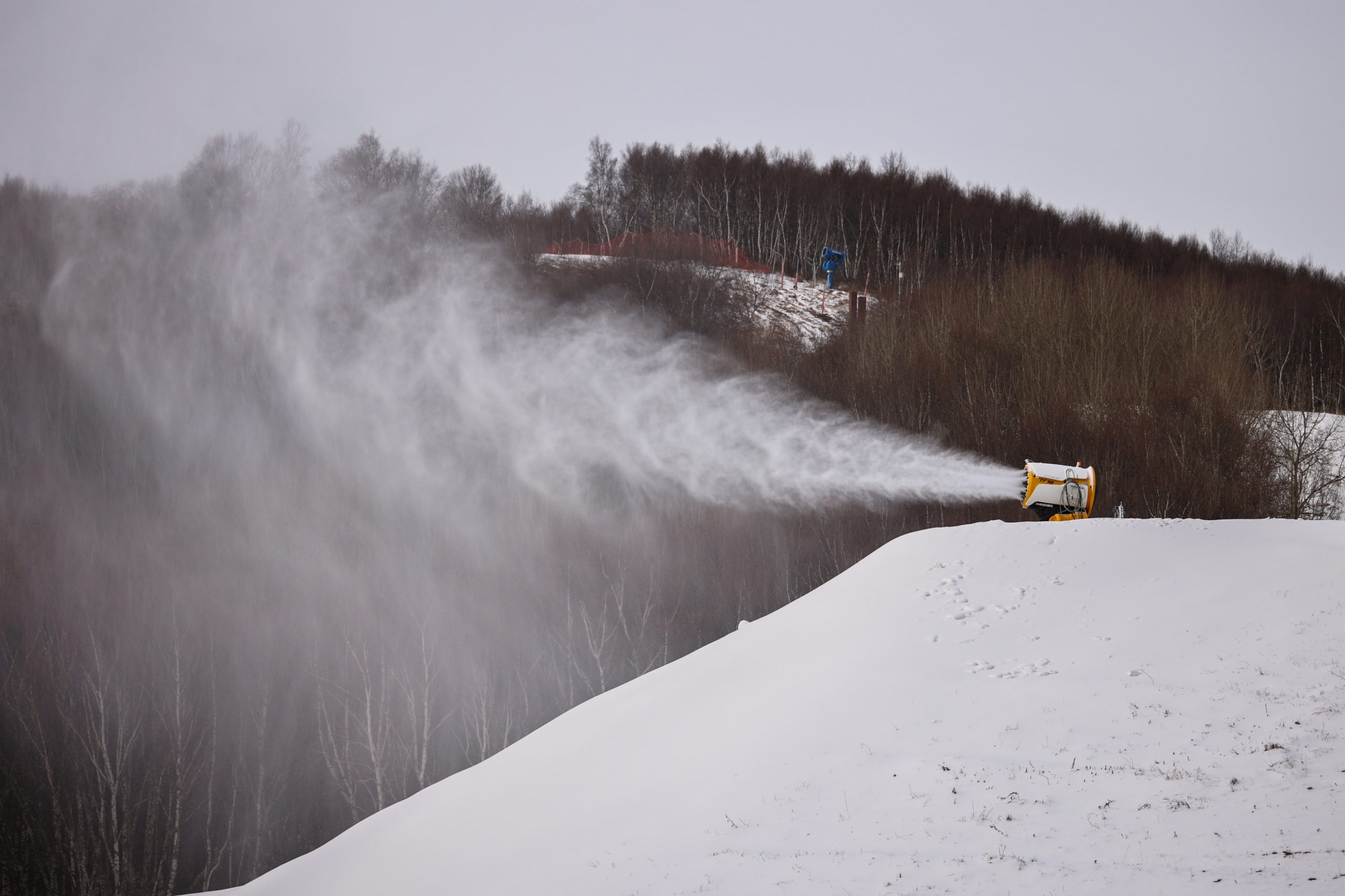FILE PHOTO: A TechnoAlpin snow gun sprays snow onto a slope for recreational use at the Genting ski resort in Zhangjiakou near venues of the Beijing 2022 Winter Olympics, Hebei province, China, November 20, 2021. 