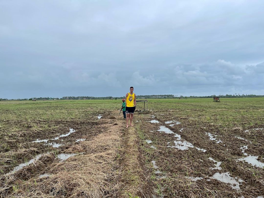 Troy Rosario poses with a piece of farm land he now owns. 