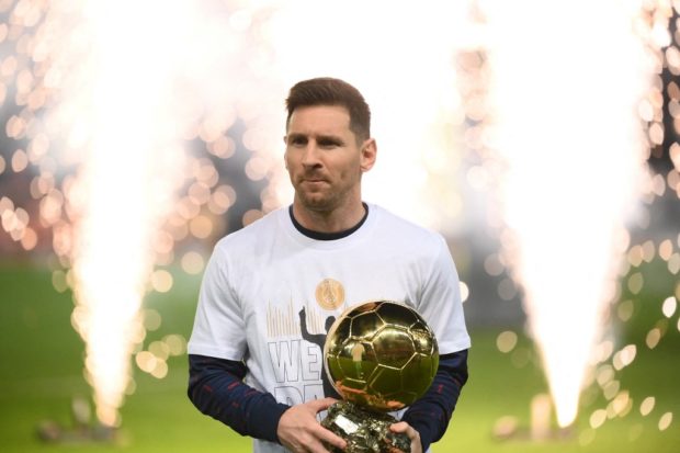 Paris Saint-Germain's Argentinian forward Lionel Messi presents his men's Ballon d'Or award prior to the French L1 football match between Paris-Saint Germain (PSG) and OGC Nice at The Parc des Princes Stadium in Paris on December 1, 2021.