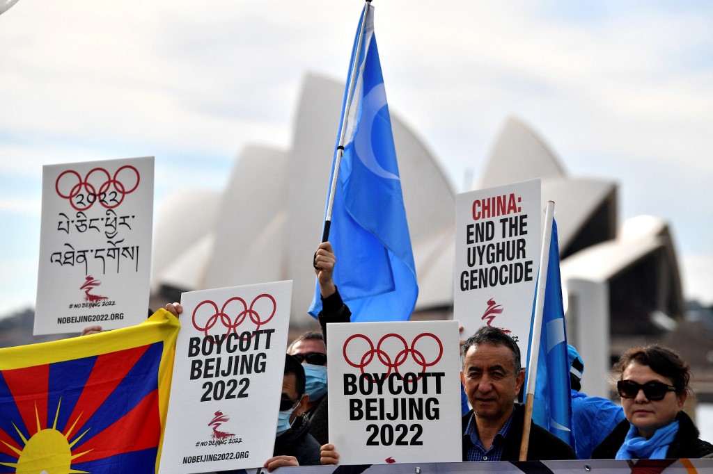 (FILES) In this file photo taken on June 23, 2021 protesters hold up placards and banners as they attend a demonstration in Sydney to call on the Australian government to boycott the 2022 Beijing Winter Olympics over China's human rights record. - The United States announced a diplomatic boycott of the Beijing 2022 Winter Olympics, a rebuke of China's human rights record that stops short of preventing US athletes from competing. White House Press Secretary Jen Psaki said on December 6, 2021 that the administration would send no diplomatic or official representation to the Games given China's "ongoing genocide and crimes against humanity in Xinjiang and other human rights abuses." (Photo by Saeed KHAN / AFP)