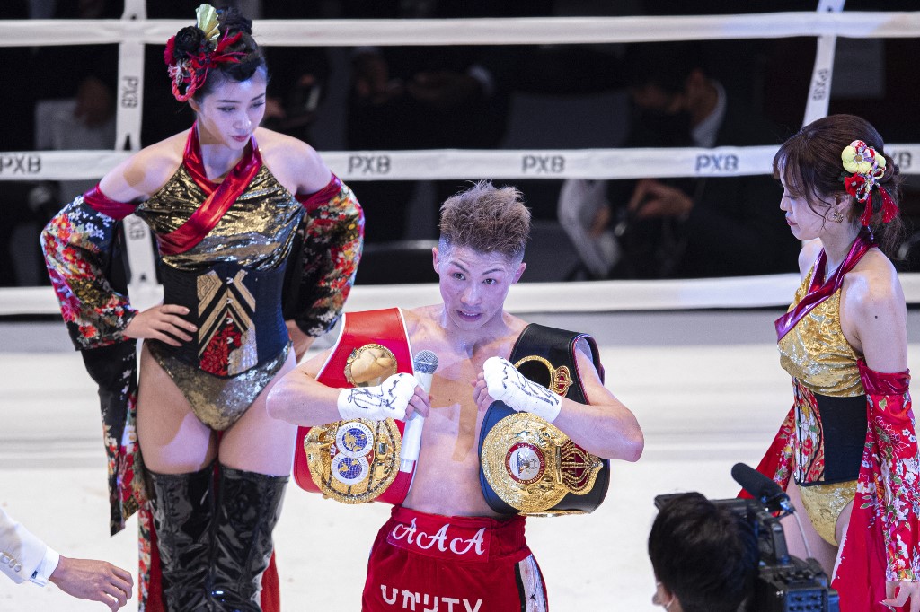 Japan's Naoya Inoue celebrates after winning against Thailand's Aran Dipaen during their WBA and IBF bantamweight title fight boxing match at the Kokugikan Arena in Tokyo on December 14, 2021. 