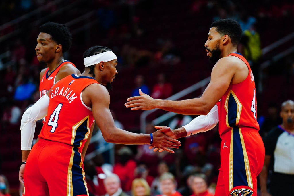 Devonte' Graham #4 of the New Orleans Pelicans hi fives Garrett Temple #41 of the New Orleans Pelicans after a made shot during the game against the Houston Rockets at Toyota Center on December 5, 2021 in Houston, Texas. 
