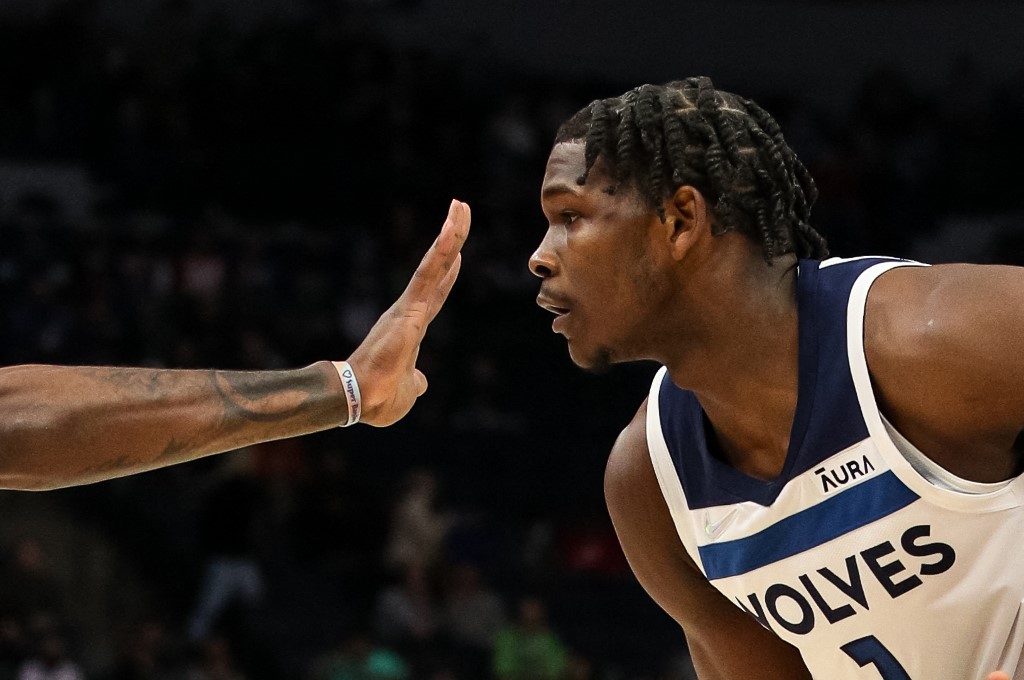 Anthony Edwards #1 of the Minnesota Timberwolves looks at the hand of Royce O'Neale #23 of the Utah Jazz in the first quarter at Target Center on December 8, 2021 in Minneapolis, Minnesota. 