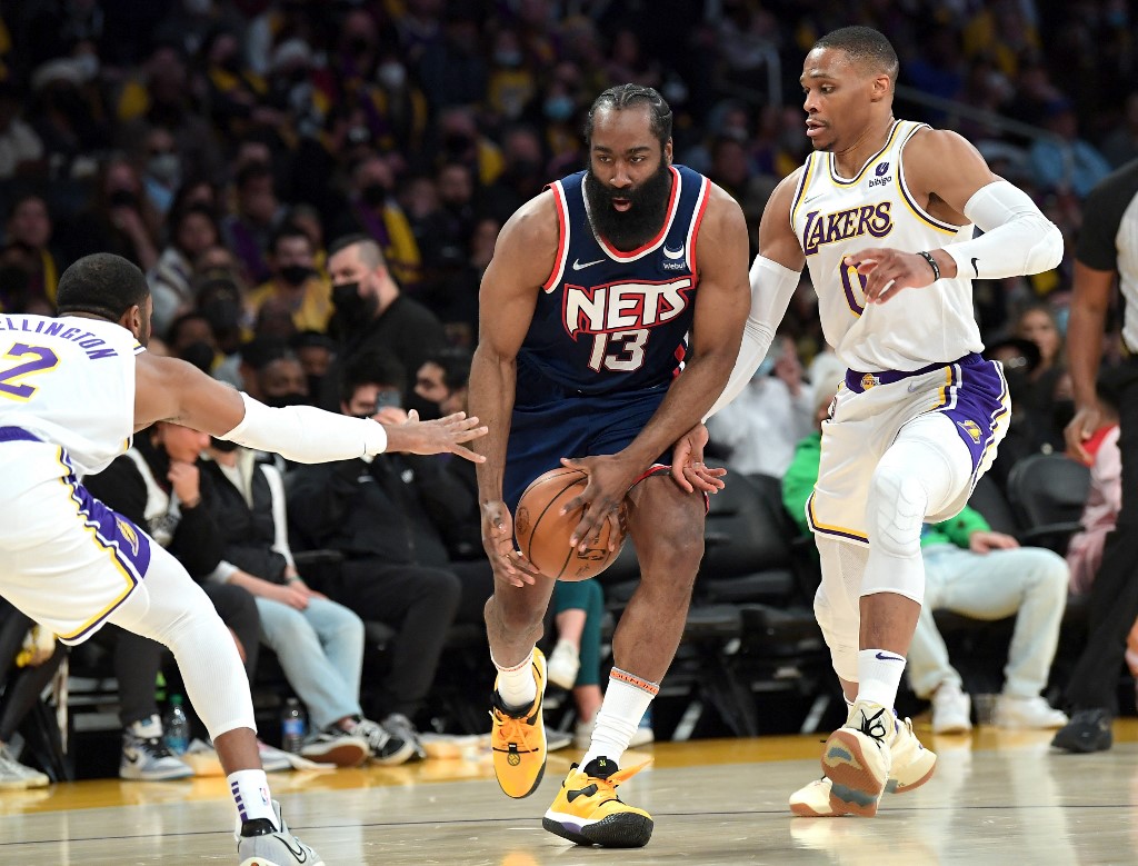  Wayne Ellington #2 and Russell Westbrook #0 of the Los Angeles Lakers defend James Harden #13 of the Brooklyn Nets as he drives to the basket in the first half of the game at Crypto.com Arena on December 25, 2021 in Los Angeles, California