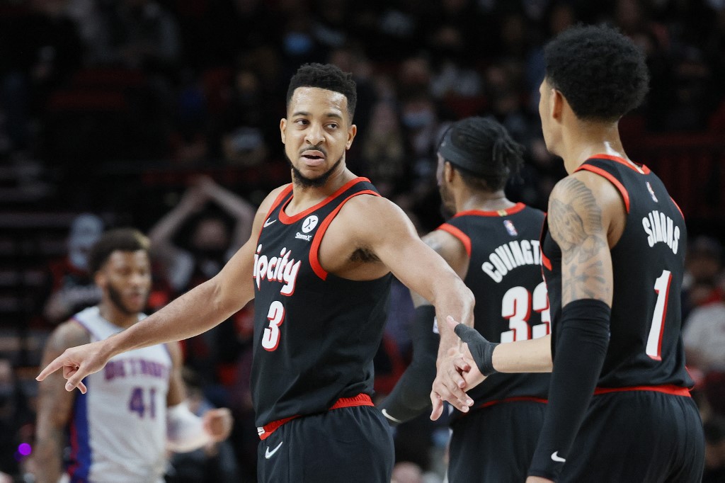  CJ McCollum #3 of the Portland Trail Blazers slaps hands with Anfernee Simons #1 during the third quarter against the Detroit Pistons at Moda Center on November 30, 2021 in Portland, Oregon. 