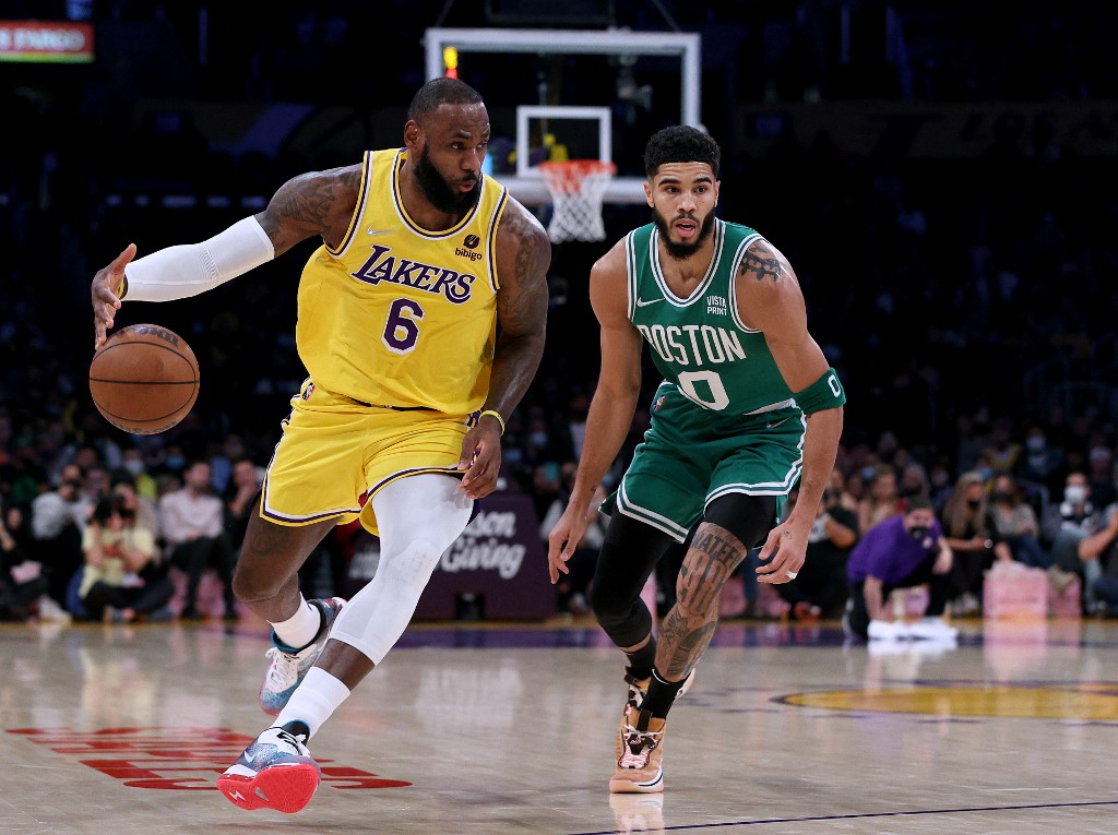 LeBron James #6 of the Los Angeles Lakers dribbles past Jayson Tatum #0 of the Boston Celtics during the first half at Staples Center on December 07, 2021 in Los Angeles, California. 