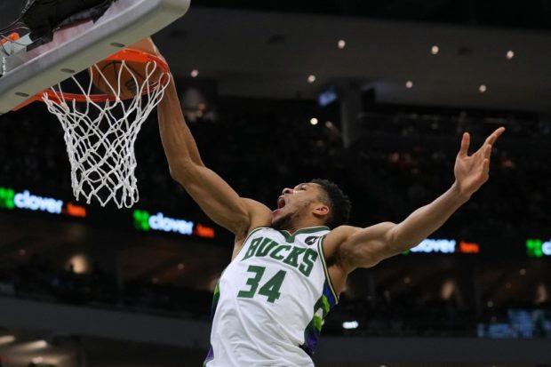 Giannis Antetokounmpo 34 of the Milwaukee Bucks makes a dunk against the Boston Celtics in the second half at the Fiserv Forum on December 25, 2021 in Milwaukee, Wisconsin.
