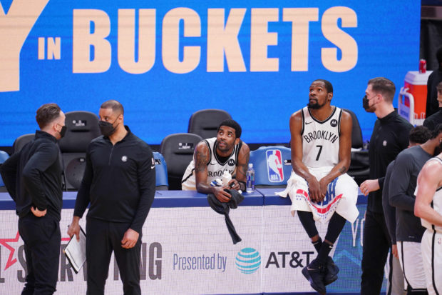 Brooklyn Nets guard Kyrie Irving (11) and forward Kevin Durant (7) rest near the team bench during a timeout against the Golden State Warriors in the fourth quarter at the Chase Center. Mandatory Credit: Cary Edmondson-USA TODAY Sports