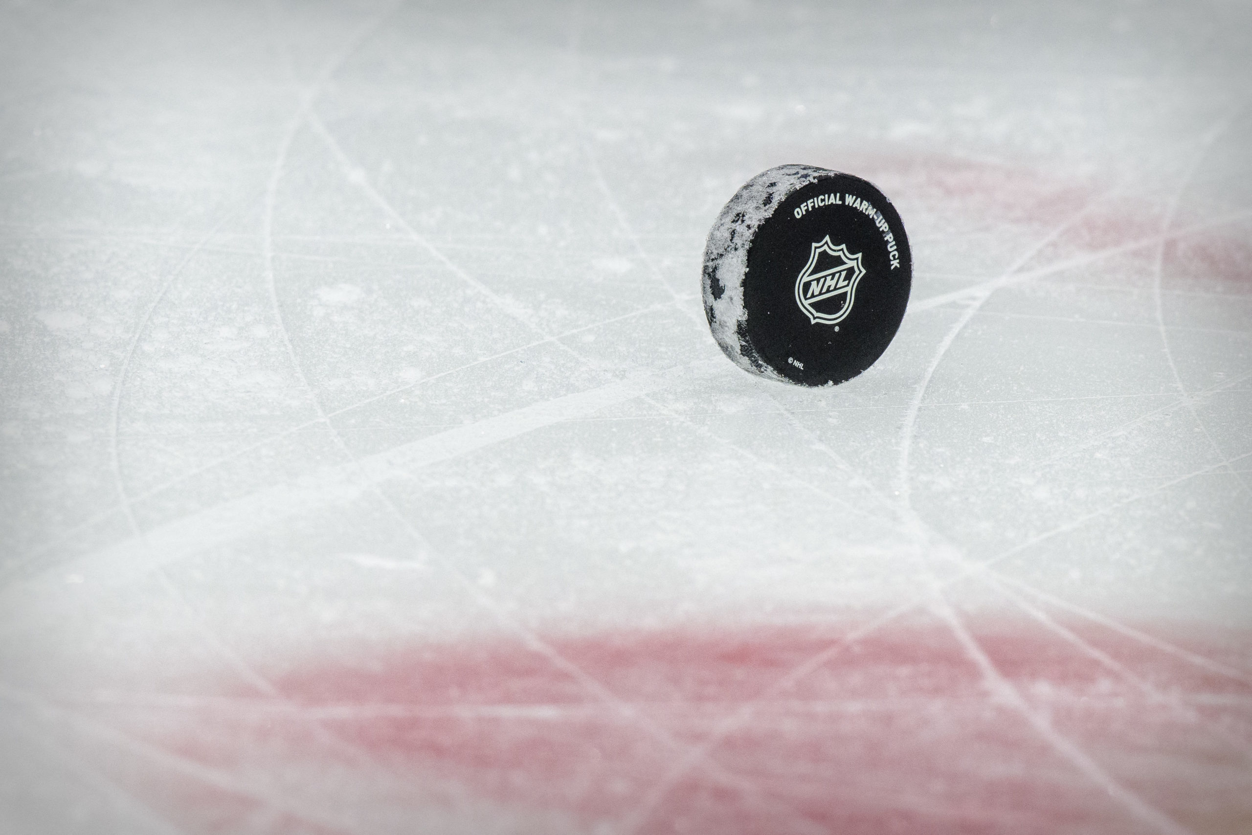 FILE PHOTO: Jan 26, 2021; Dallas, Texas, USA; A view of a puck and the NHL logo and the face-off circle before the game between the Dallas Stars and the Detroit Red Wings at the American Airlines Center. 