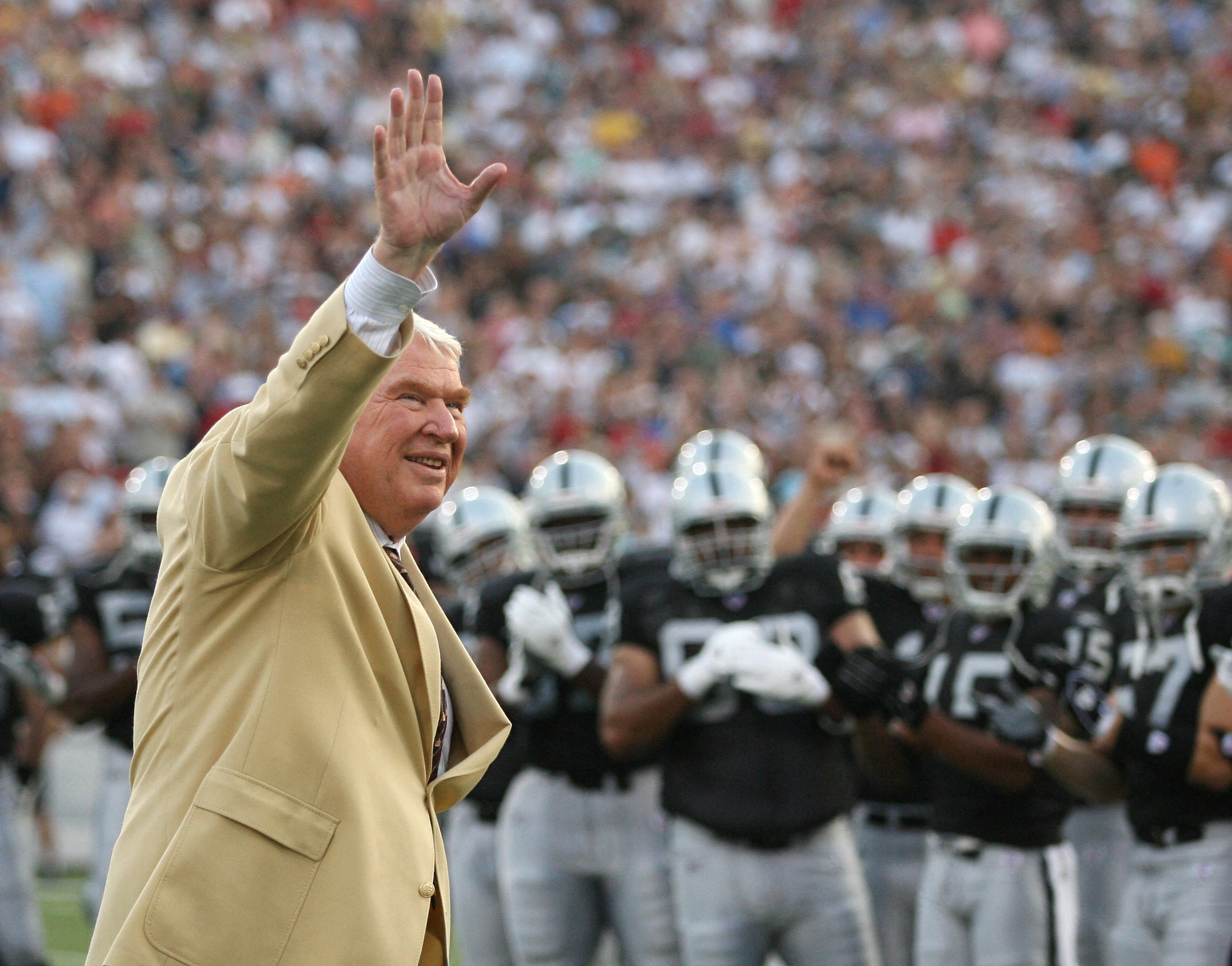 FILE PHOTO: Former Oakland Raiders head coach John Madden waves to the crowd before the AFC-NFC Hall of Fame pre-season game in Canton, Ohio, August 6, 2006. 