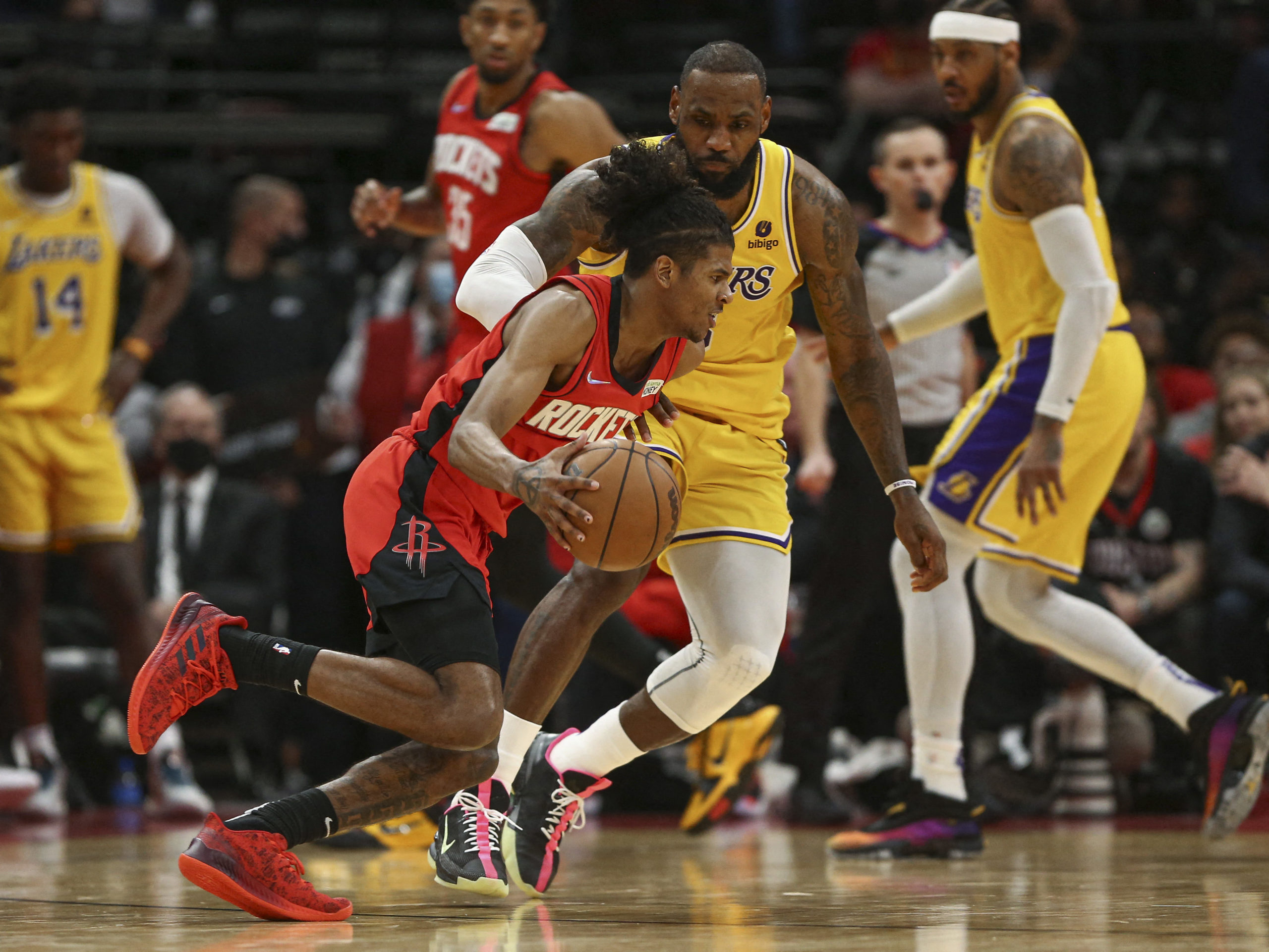 Houston Rockets guard Jalen Green (0) dribbles the ball as Los Angeles Lakers forward LeBron James (6) defends during the fourth quarter at Toyota Center. Dec 28, 2021;
