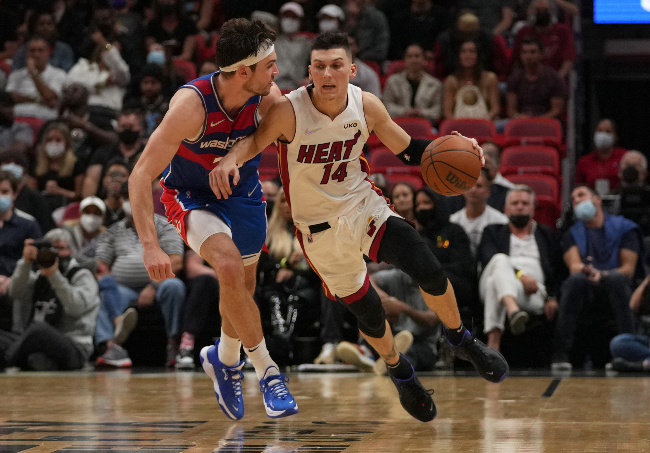 Washington Wizards forward Corey Kispert (24) fouls Miami Heat guard Tyler Herro (14) during the second half at FTX Arena. Dec 28, 2021; Miami, Florida, USA