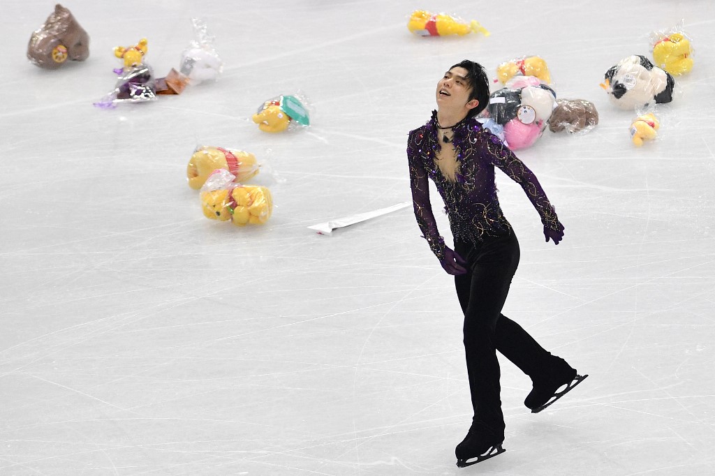 Japan's Yuzuru Hanyu reacts after performing, as stuffed toys thrown by fans scatter the ice rink, during the Men Free Skating program on December 7, 2019 at the ISU Grand Prix of figure skating Final 2019 in Turin.
