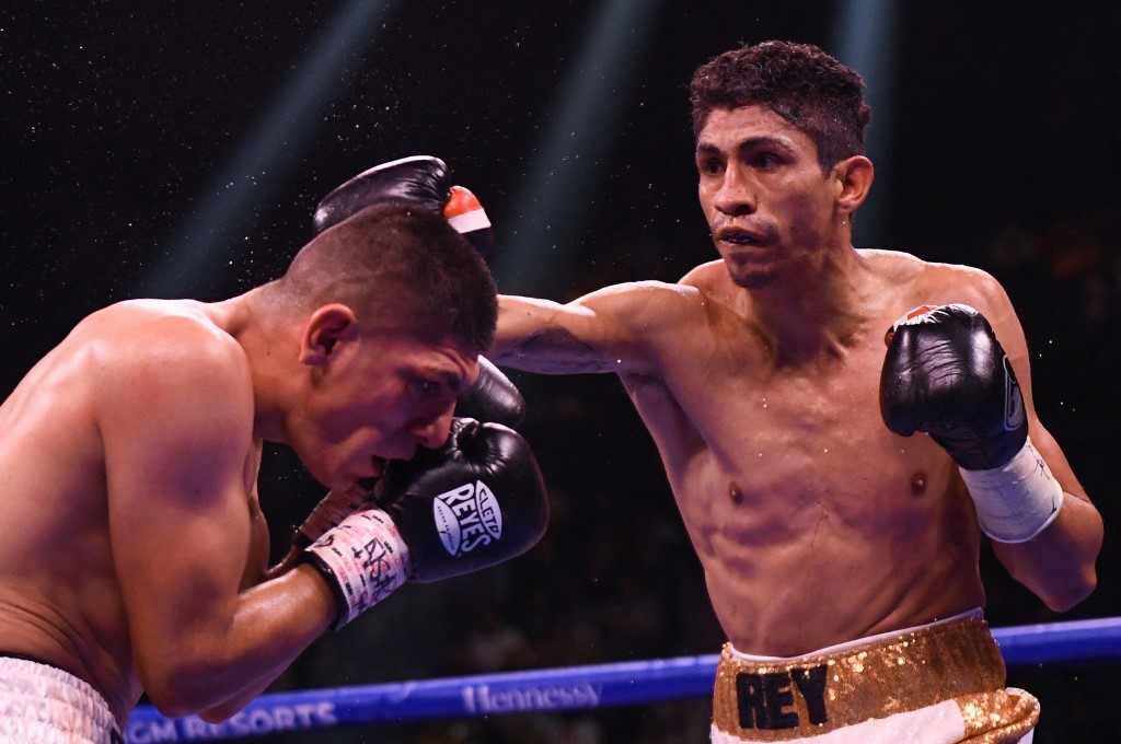 Rey Vargas of Mexico (R) lands a punch to Leonardo Baez of Mexico (L) during their featherweights boxing match at MGM Garden Arena in Las Vegas, Nevada on November 6, 2021.