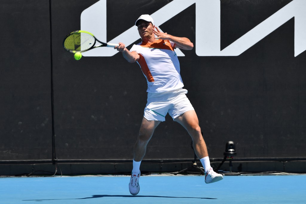 Serbia's Miomir Kecmanovic hits a return against Italy's Lorenzo Sonego during their men's singles match on day five of the Australian Open tennis tournament in Melbourne on January 21, 2022.