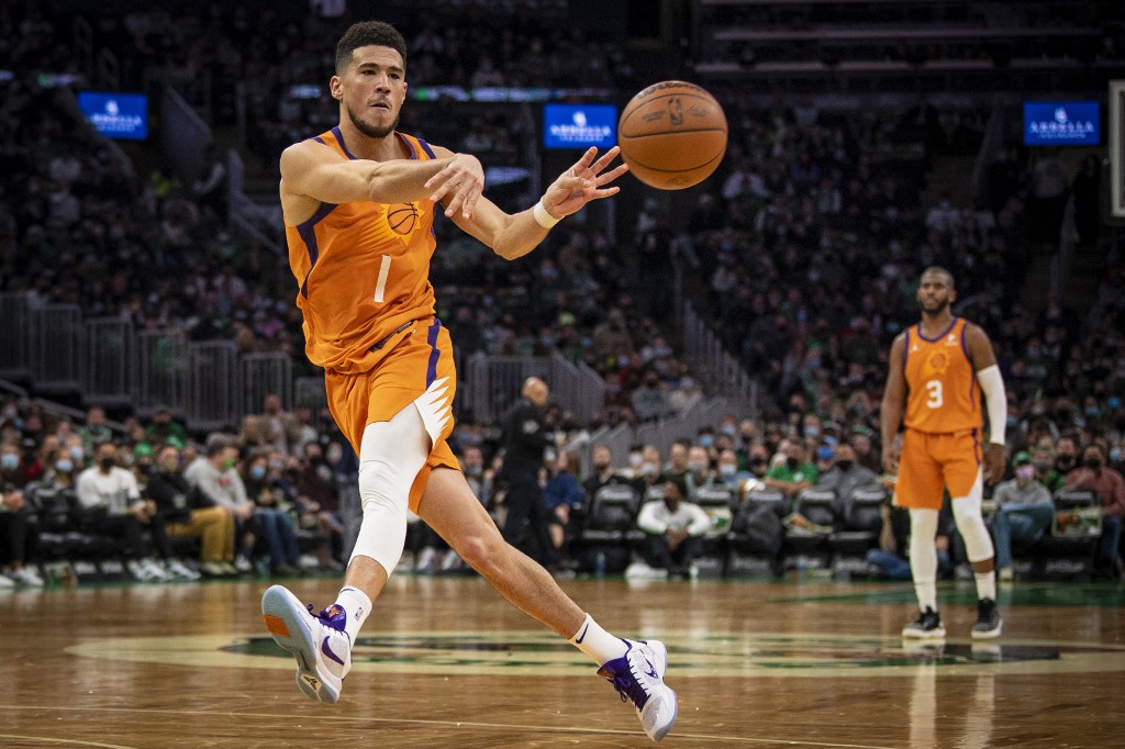 Devin Booker #1 of the Phoenix Suns passes the ball during the second half of a game against the Boston Celtics at TD Garden on December 31, 2021 in Boston, Massachusetts. NOTE TO USER: User expressly acknowledges and agrees that, by downloading and or using this photograph, User is consenting to the terms and conditions of the Getty Images License Agreement.