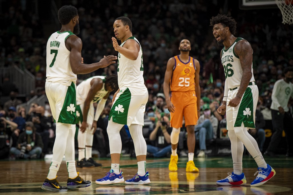 Jaylen Brown #7, Grant Williams #12, and Marcus Smart #36 of the Boston Celtics react during the second half against the Phoenix Suns at TD Garden on December 31, 2021 in Boston, Massachusetts.